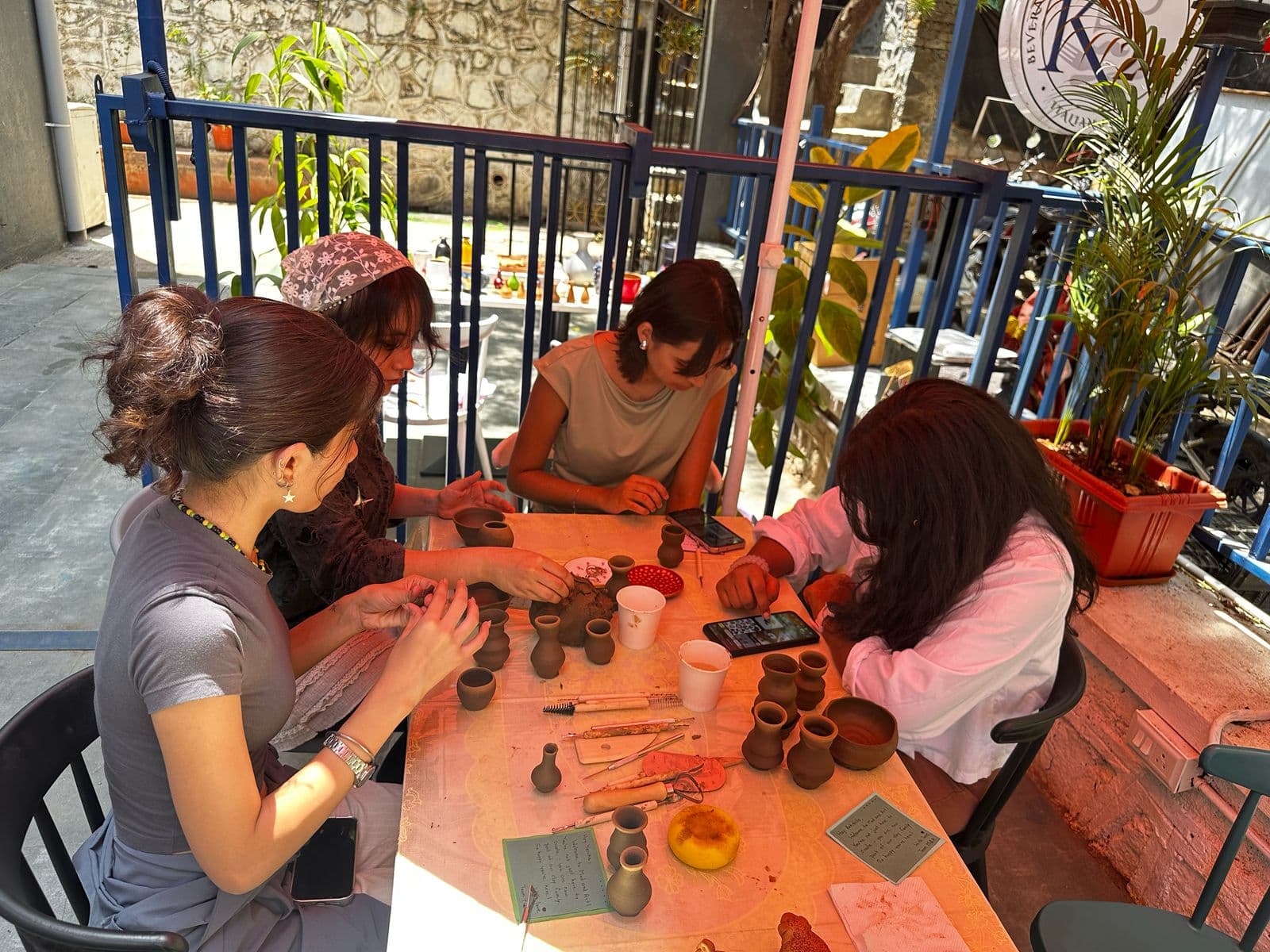 Hands centering clay on a pottery wheel