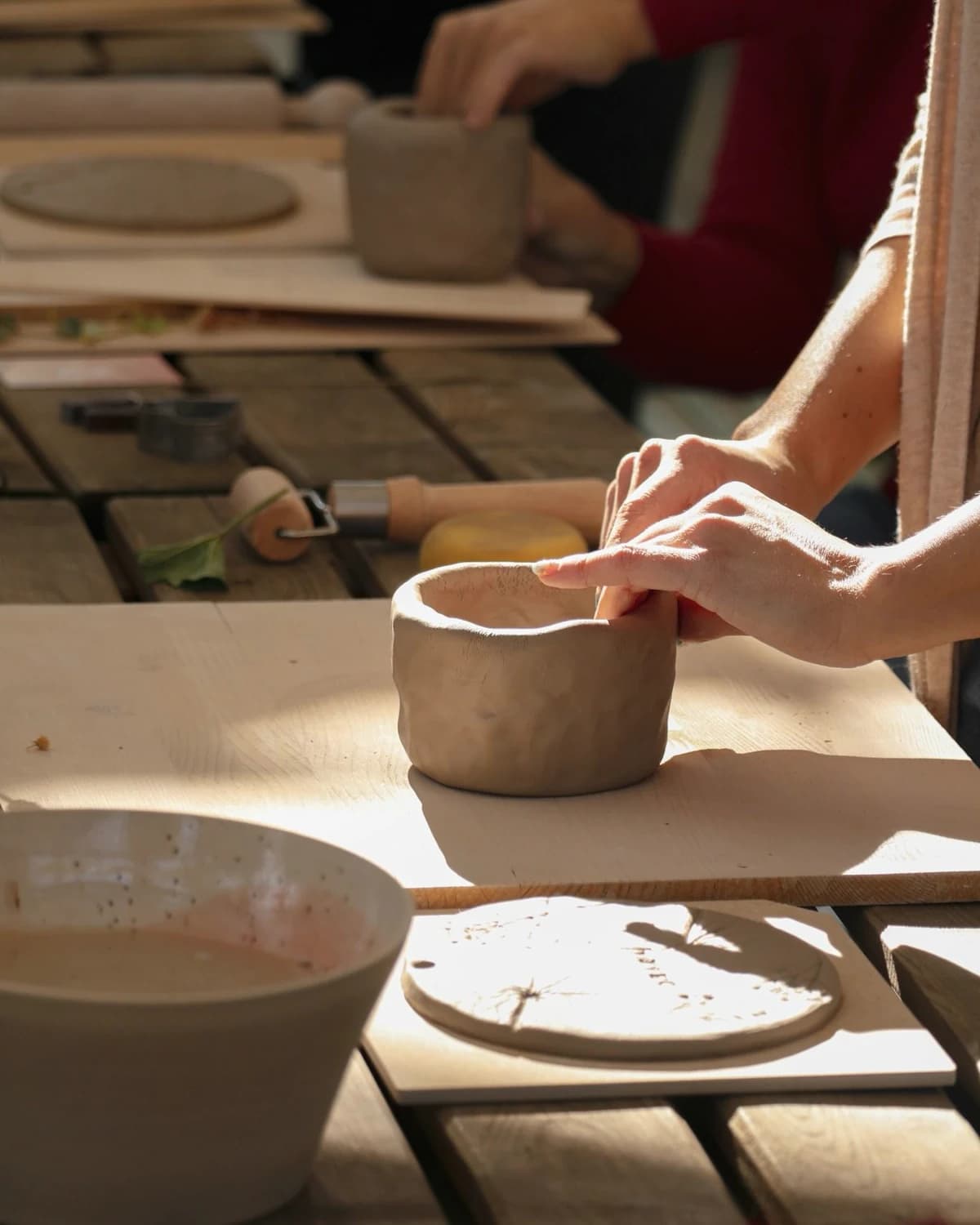 Participant glazing a handmade bowl